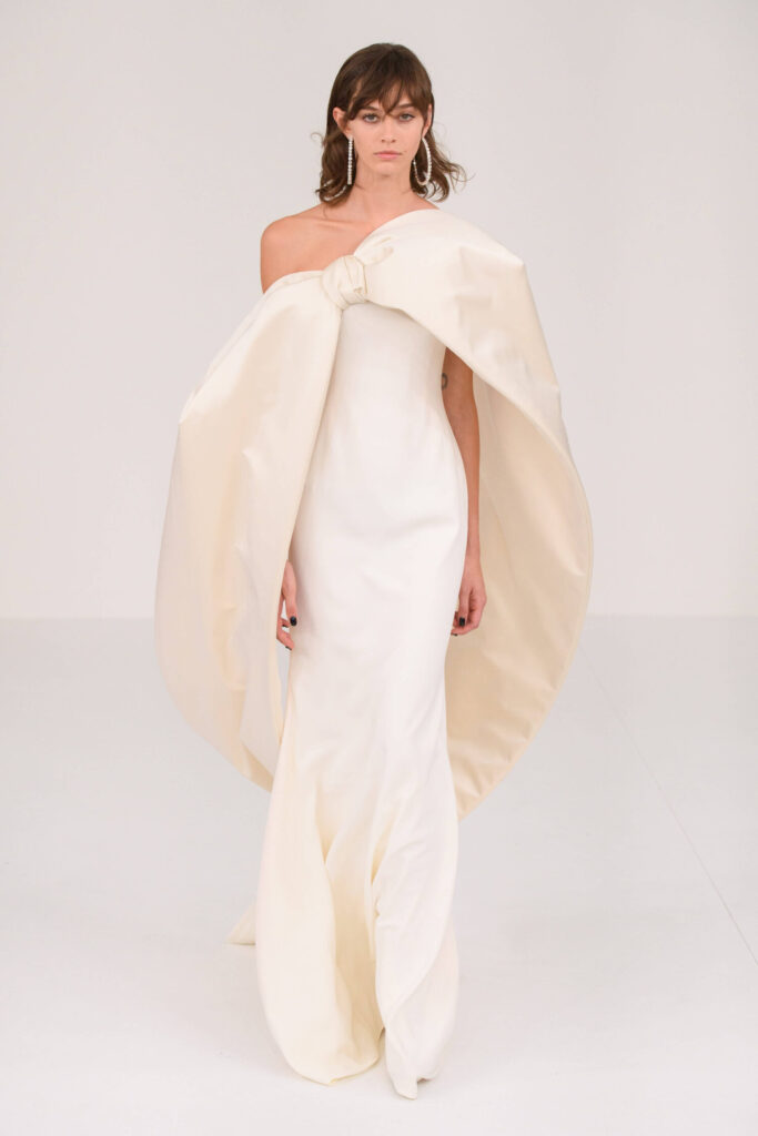 De grootste trends van Paris Haute Couture Week waarbij een model een asymetrische witte jurk draagt. 