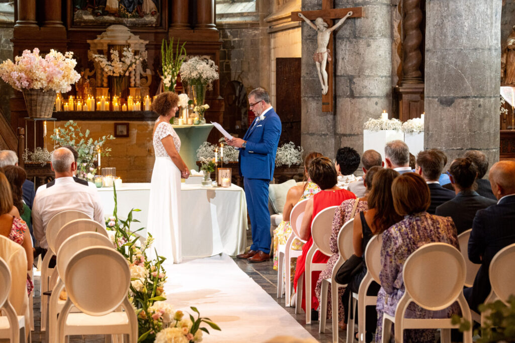 Trouwceremonie en trouwfeest in de kerk: bruid en bruidegom staan tegenover elkaar en lezen hun huwelijksgeloften voor. 